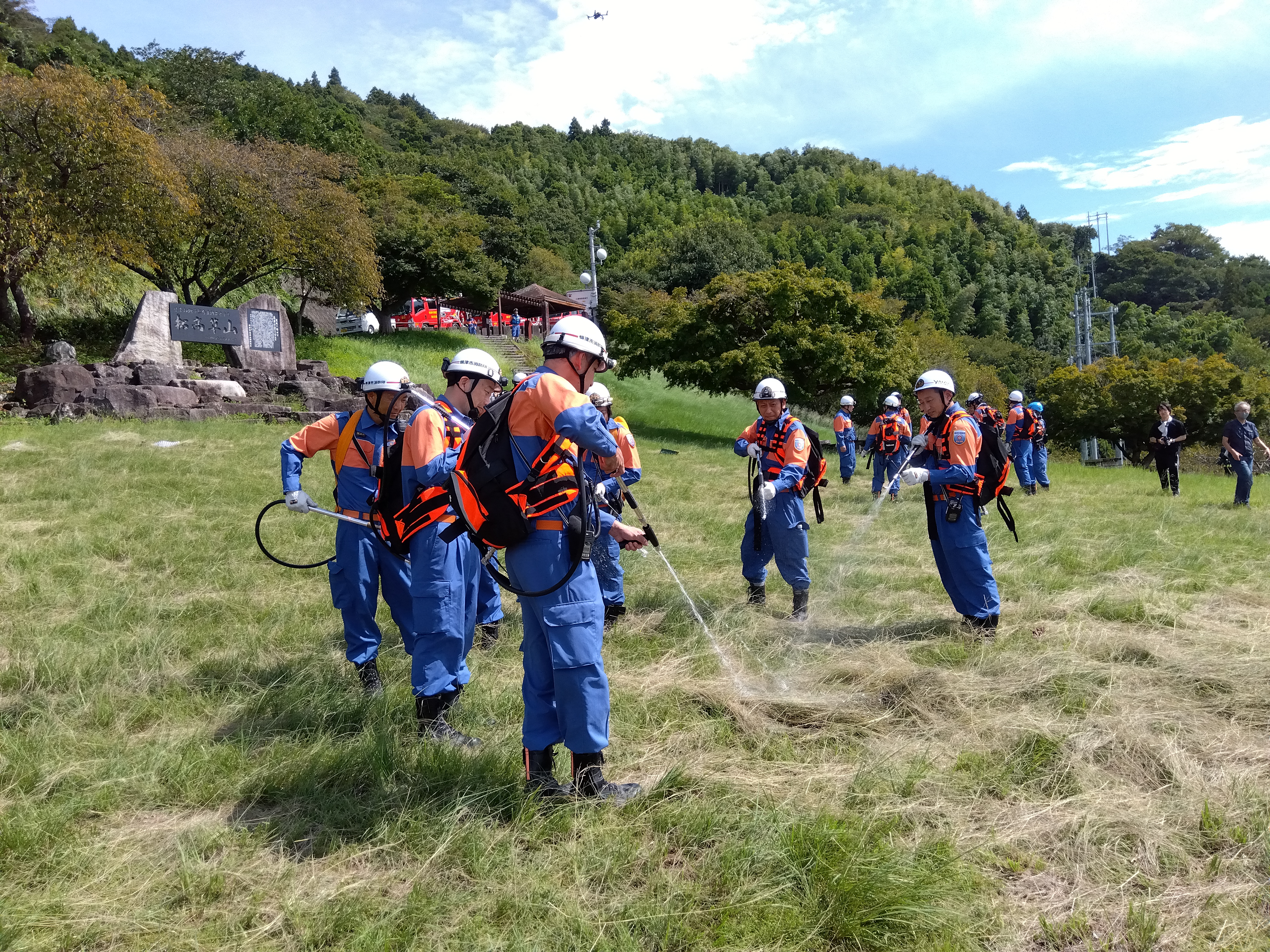 背負式消火器具を使って消火訓練を行う消防団員